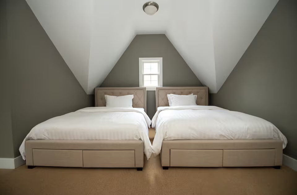 Open loft sleeping area with twin beds at Spacious Modern Hideaway